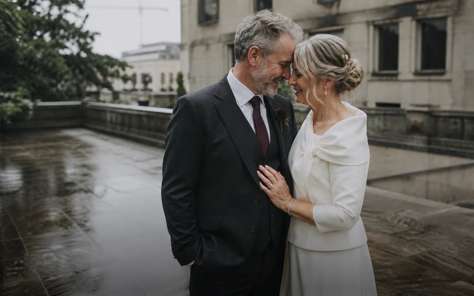 A mature newly married couple sharing a quiet moment outside their ceremony